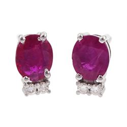 Pair of 18ct white gold oval ruby and diamond stud earrings, total ruby weight approx 1.10 carat
