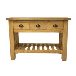 Modern light oak dresser, the flat top over three fitted drawers, with pot board base, raised on square supports
