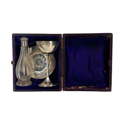 Victorian travelling communion set comprising silver paten and chalice inscribed 'IHS' Birmingham 1864 Maker Henry Hyde Ashton and a glass holy oil or water bottle with white metal cover in fitted leather case 
