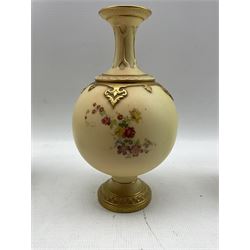 Three Royal Worcester blush ivory vases comprising a late 19th century twin-handled vase and cover, painted and gilded with floral sprays shape no. 1553, H28cm (a/f), another late 19th century vase of globular form and lobed jar painted with thistles, lacking cover (3)
