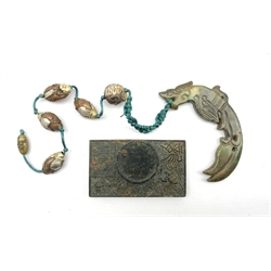 Chinese rectangular inkstone decorated in relief with a Dragon amidst clouds and script, 9.5cm x 5.5cm, together with a green hardstone carved Dragon amuet suspended on a cord mounted with figural metal beads (2)