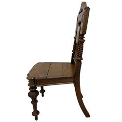 Victorian oak hall chair, the shield back carved and pierced with fan motifs with spiral turned pilasters, baluster turned supports with carved tulip decoration