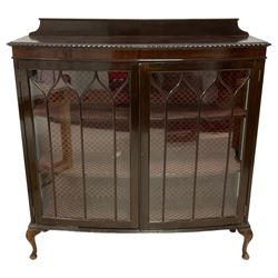 Early 20th century mahogany bow-front display cabinet, raised back over gadroon moulded top, two astragal gazed doors enclosing two shelves, on cabriole feet