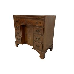 Georgian style mahogany kneehole desk, rectangular top over brushing slide, fitted with single frieze drawer above six graduating short drawers flanking recessed central cupboard, raised on bracket feet