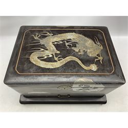 Japanese black lacquer sewing box inset with silver coloured dragons, the red lacquered interior with lift out tray and covered containers, single drawer under on a stand with shaped supports 40cm x 30cm x 27cm 