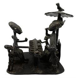 Nigerian Benin bronze group depicting a seated Oba eating under a parasol, another seated figure opposite and children, on rectangular base, H13cm x W14cm