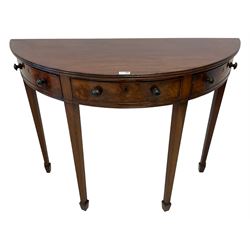 George III mahogany demi-lune side or console table, reeded edge over central frieze drawer flanked by two hinged drawers with cock-beaded facias and turned handles, raised on square tapering supports with spade feet, the rear supports and feet chamfered in profile