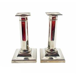 Pair of George V silver candlesticks with panel sided columns and stepped square bases , H 15cm Sheffield 1915 Maker Hawksworth Eyre & Co. 