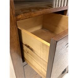 Arts and Crafts style oak chest, open shelf with slatted sides over two short and three long graduated drawers, raised on stile supports W87cm, H125cm, D48cm