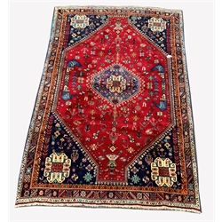 Persian Qashqai ground rug, with lozenge medallion on red field decorated with stylised animals and geometric designs, 308cm x 210cm