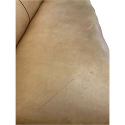 Victorian style low sofa, upholstered in beige leather, raised on turned feet, one bearing a 'Holland & Sons' stamp W225cm