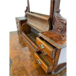 Victorian figured walnut Duchess dressing table, raised swing mirror back with bevelled plate, flanked by carved scroll and foliate decorated supports over a hinged dome compartment flanked by two banks of three drawers, the serpentine front fitted with single frieze drawer, raised on turned and lobe carved baluster supports with a shaped platform base