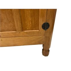 Mouseman - adzed oak sideboard, raised back over rectangular top, fitted with three central graduating drawers flanked by two panelled cupboards with wrought metal hinges and fittings, raised on octagonal supports, carved with mouse signature, by the workshop of Robert Thompson, Kilburn