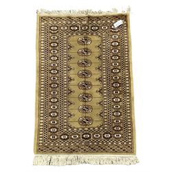 Small beige Bokhara rug with one central line of Gul motifs surrounded by border  