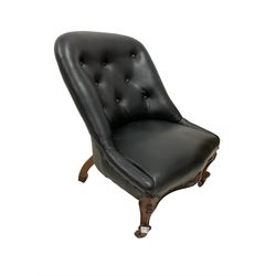 Nursing chair, upholstered in black leather with carved apron,  raised on cabriole supports, terminating in ceramic castors 