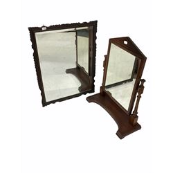 19th century dressing swing mirror with arched pediment over turned and fluted supports on a shaped platform base, (71cm x 90cm) together with an early 20th century bevel edge wall mirror in a chip carved oak frame (71cm x 93cm)