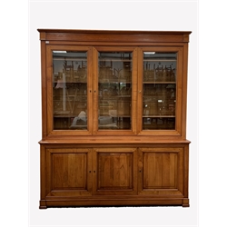  Large 20th century cherry French style library bookcase, three glazed doors with bevelled plates enclosing six adjustable shelves, three cupboards to base, W196cm, H226cm, D52cm  