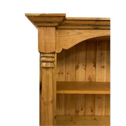 Pine floor standing open bookcase, projecting moulded cornice over shelves, enclosed by two half column pilasters, on moulded plinth base