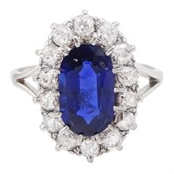 Early - mid 20th century platinum oval cut sapphire and old cut diamond cluster ring, stamped Plat, sapphire approx 1.80 carat, total diamond weight approx 0.70 carat