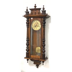 Late 19th century Vienna style wall clock, the walnut case surmounted by turned pilasters, ivorine dial with Roman chapter ring, eight day spring driven movement striking hammer on coil H130cm