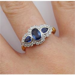18ct gold three stone pear and oval cut sapphire ring, with diamond surround