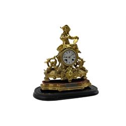 A French gilt spelter striking mantle clock housed under a glass dome c 1880, decorative gilt case on a padded wooden plinth with a depiction of an artist in 18th century dress reclining on a drum case with an eight-day Japy Freres movement, enamel dial with Roman numerals, steel spade hands and minute markers, with a twin train countwheel movement striking the hours and half hours on a bell, engraved silver presentation plaque dated 1886, with original oval glass dome on an ebonised wooden plinth
With pendulum & original bow key.




