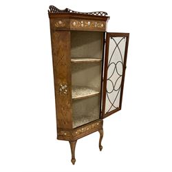 Victorian inlaid walnut floor-standing corner cabinet, the raised back pierced with fretwork with beaded front edge, the frieze inlaid with satinwood and mother of pearl floral designs within an ebony band boxwood striped border, single glazed door enclosing two shelves, raised om cabriole supports