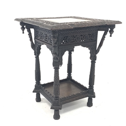  19th century Eastern oak occasional table, the top carved with trailing foliate over figures to each corner, leaf carved supports united by undertier, 51cm x 50cm, H62cm  