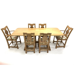 Yorkshire oak dining suite, comprising oak dining table, the rectangular top raised on shaped panel end supports carved with Yorkshire rose roundels, raised on sledge feet and united by pegged stretcher, (193cm x 84cm, H74cm) together with a set of six (4+2) oak dining chairs, with Yorkshire rose carving and drop in upholstered seat pads, raised on ring turned and block supports (W57cm)  all carved with initials 'J N' and dated '1977'