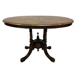 Victorian walnut loo table, the oval tilt marquetry top leading into base with four splayed supports 