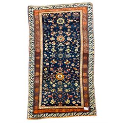 Persian blue ground rug, the field decorated with five large Herati motifs and stylised flower heads, repeating rust ground border bands