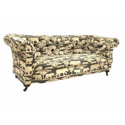 Victorian chesterfield sofa, upholstered in Andrew Martin deep buttoned animal print velvet fabric, raised on turned supports with ceramic castors L200cm