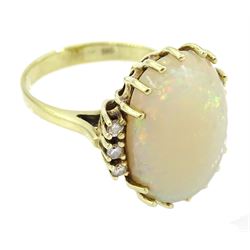 14ct gold oval opal ring, each side set with three diamonds, stamped 585
