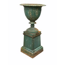 Cast iron urn on plinth, flared leaf cast rim over lobed body raised on a similar socle and stepped square tapered plinth H93cm