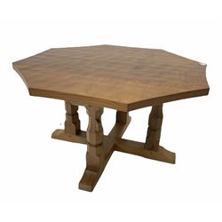 Robert 'Mouseman' Thompson of Kilburn - Yorkshire oak coffee table, the octagonal adzed top raised on four faceted octagonal supports leading to a cruciform base, pegged construction and carved with mouse signature W91cm, H48cm