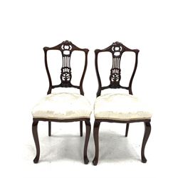 Pair Edwardian carved walnut framed bedroom chairs with cream damask seats and slender supports W45cm