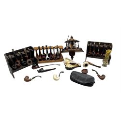 Collection of pipes including a Orlik Hurricane, two carved meerschaum pipes, Parker pipe,  and others including ceramic and carved examples, together with four pipe racks