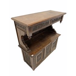 Early 20th century oak buffet side cabinet, the raised back with moulded top over two drawers, three panel back and two cupboards under, raised on turned supports, profusely carved with foliate all over W123cm, H126cm, D49cm
