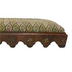 Victorian mahogany hearth stool, seat upholstered in foliate patterned tapestry beadwork, applied curved frieze, raised on scrolled cabriole feet (W135cm); 19th century walnut ecclesiastical kneeler stool, upholstered in floral needlework, the figured base with applied gilt cross mounts(W108cm)