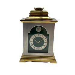 Thwaites and Reed twentieth century carriage clock in a brass and steel finished case with an inverted bell top and carrying handle, silvered chapter ring with Roman numerals and pierced brass hands, eight-day spring driven movement with a lever platform escapement. With key. 