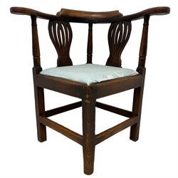 18th century elm corner elbow chair, the shaped back and arms with scrolled terminals on turned supports and pierced vasiform splats, square seat with drop-in cushion on square supports joined by plain stretchers