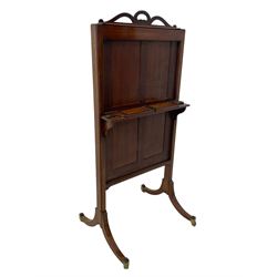 Early 19th century mahogany cheval dressing mirror, ribbon shaped pediment, the rectangular plate on an adjustable sliding sash with panelled back, retractable  stands to either side, raised on splayed end supports with brass capped feet and castors 