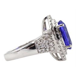 18ct white gold oval tanzanite and two row round brilliant cut diamond cluster ring, with diamond set shoulders, stamped 750, tanzanite approx 5.35 carat, total diamond weight approx 1.00 carat