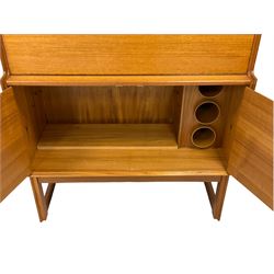 Turnidge of London - mid-20th century teak drinks cabinet, top section with fall-front enclosing mirror backed drinks area with shelf, bottom section with two cupboard doors concealing bottle rack and shelf, raised on shaped supports