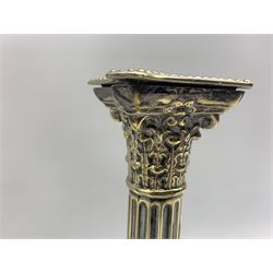 Two pairs of Victorian silver-plated Corinthian column candlesticks, the smaller pair with acanthus capital, fluted column entwined with ivy, on a square stepped, beaded and bases, circa 1889 and a similar pair, H32cm (4)