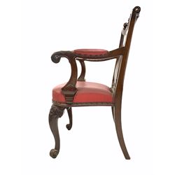 Victorian walnut armchair, the scrolled crest rail with carved mask over splat back, upholstered in studded faux lather, raised on scrolled carved cabriole supports (W 66cm)