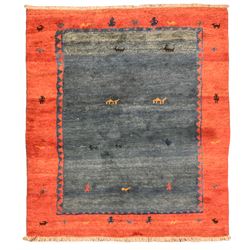 Persian Gabbeh indigo ground thick pile carpet, the field and thick red border decorated with stylised animal and camel motifs, with weaver figures around the guard stripe, retailed by Fired Earth