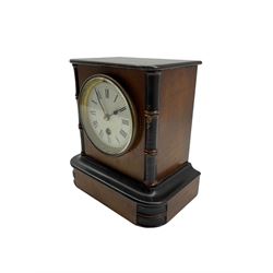 French timepiece mantle clock c1890 in a mahogany case with ebonised detail, enamel dial with roman numerals and steel spade hands, within a cast brass bezel and flat bevelled glass. With pendulum.
