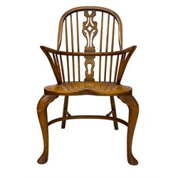 Elm Windsor chair, high back with pierced splat and spindle supports over shaped saddle seat, raised on cabriole front supports united by crinoline stretcher