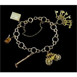 Gold link bracelet with five gold charms including set of keys, carriage and wheelbarrow, all 9ct stamped or hallmarked